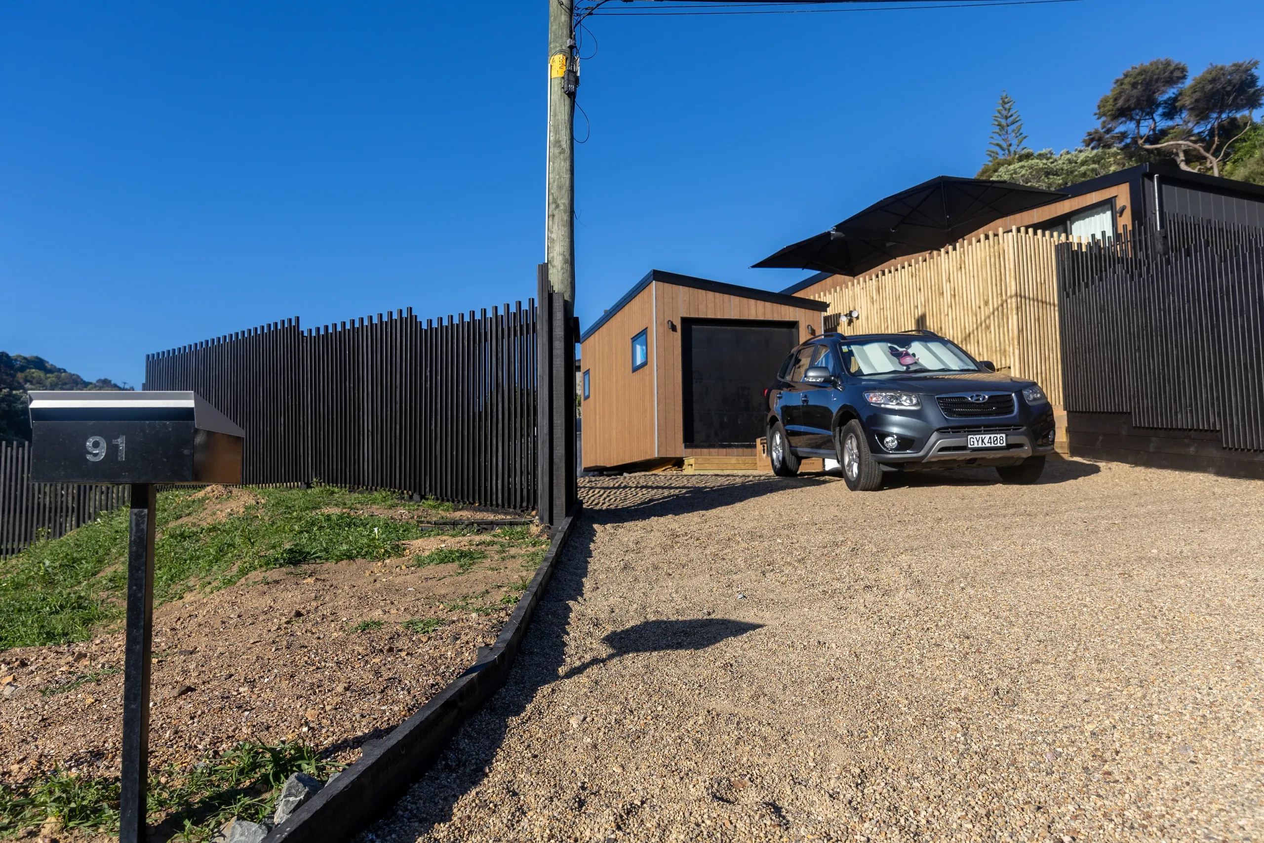 The finished driveway in use, running up to the carport on the new level platform.