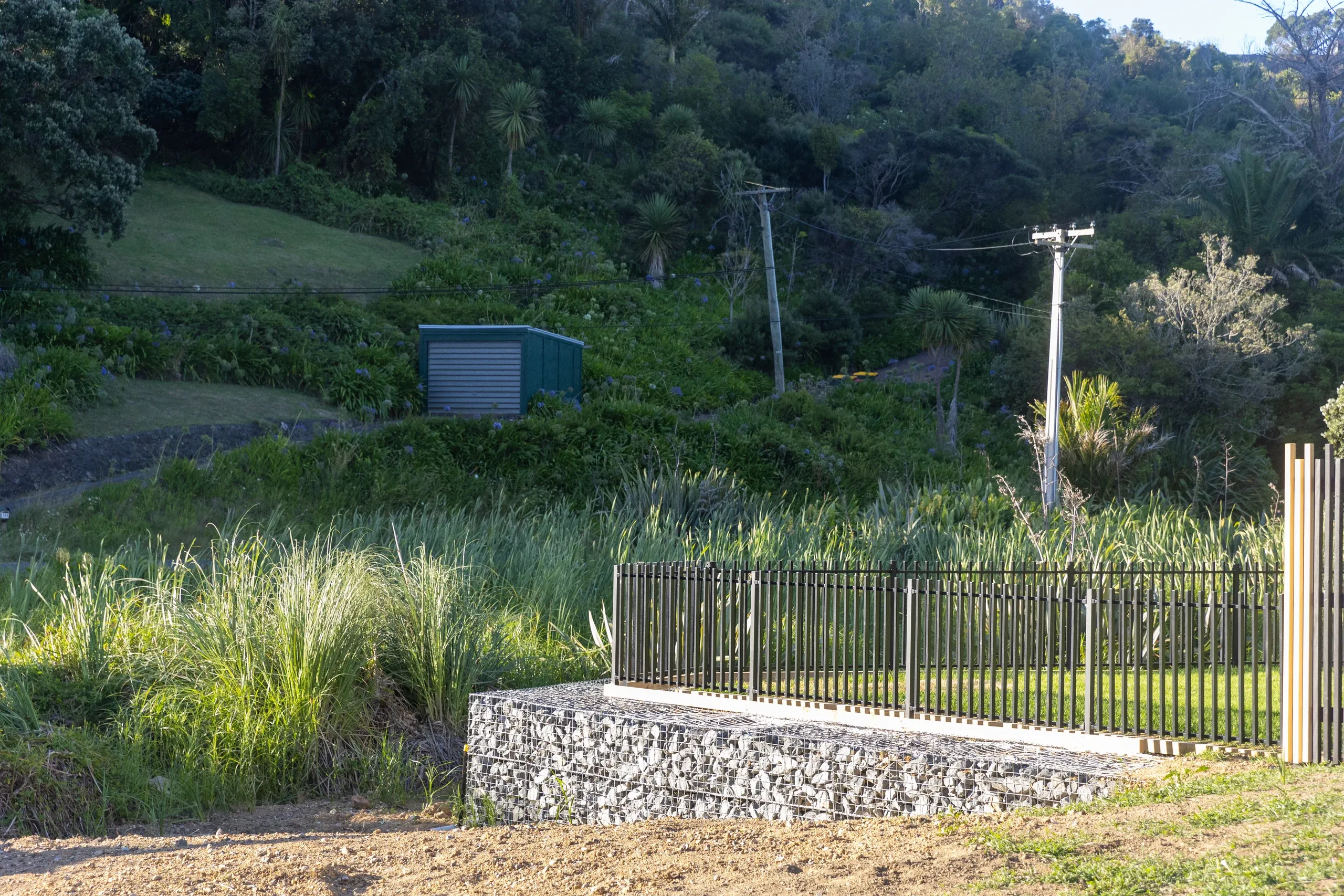 The completed frontage: new driveway, fencing and retained bank finished together.