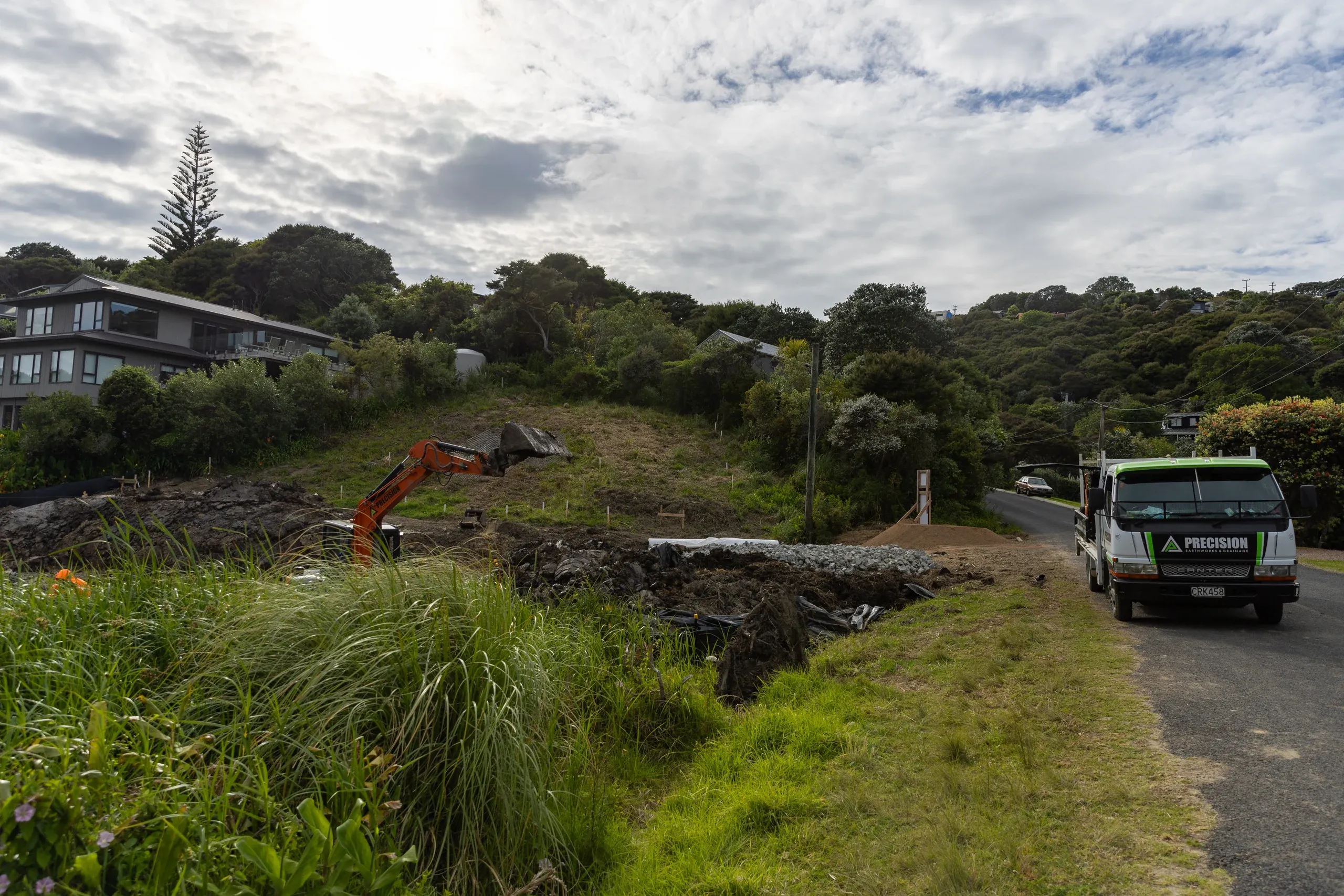 The cleared and shaped section seen wide from the road, ready for surfacing and planting.